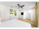 Comfortable bedroom with dresser, mounted TV, and ceiling fan at 2980 On The Rocks Pt, Kissimmee, FL 34747