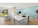Open kitchen with an island, stainless steel appliances, and a view into the living area at 2980 On The Rocks Pt, Kissimmee, FL 34747