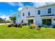 Community backyard with colorful townhouses and lush landscaping at 2980 On The Rocks Pt, Kissimmee, FL 34747