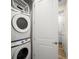 Stackable washer and dryer in a well-lit laundry room at 2980 On The Rocks Pt, Kissimmee, FL 34747