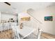 Modern dining room with white table and chairs, adjacent to kitchen at 2980 On The Rocks Pt, Kissimmee, FL 34747