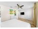 Spacious bedroom with mounted TV and ceiling fan at 2980 On The Rocks Pt, Kissimmee, FL 34747