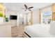 Spacious bedroom with large closet, mounted TV and ceiling fan at 2980 On The Rocks Pt, Kissimmee, FL 34747