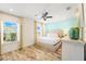 King bedroom with ceiling fan and large windows at 2980 On The Rocks Pt, Kissimmee, FL 34747