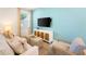 Cozy living room featuring a light colored sofa and a wall-mounted TV at 2980 On The Rocks Pt, Kissimmee, FL 34747