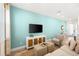 Living room features a large TV, comfortable seating, and calming light blue walls at 2980 On The Rocks Pt, Kissimmee, FL 34747