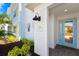 Inviting exterior with a light blue door and well-manicured landscaping at 2980 On The Rocks Pt, Kissimmee, FL 34747