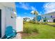 Private patio with teal adirondack chairs and lush landscaping at 2980 On The Rocks Pt, Kissimmee, FL 34747