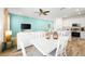 Bright dining area with white table and chairs near kitchen and living room at 2980 On The Rocks Pt, Kissimmee, FL 34747