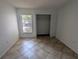 Bright bedroom featuring tile floors and a window at 2912 S Semoran Blvd # 9, Orlando, FL 32822