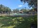 Community tennis court with chain-link fence and surrounding trees at 2912 S Semoran Blvd # 9, Orlando, FL 32822