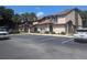 Condo building exterior with parking lot and landscaping at 2912 S Semoran Blvd # 9, Orlando, FL 32822