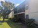Building exterior showcasing a condo with a balcony and landscaping at 2912 S Semoran Blvd # 9, Orlando, FL 32822