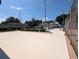Community pool with surrounding patio and tennis courts at 2912 S Semoran Blvd # 9, Orlando, FL 32822
