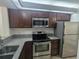 Kitchen with stainless steel appliances and granite countertops at 2912 S Semoran Blvd # 9, Orlando, FL 32822