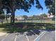 Tennis court surrounded by trees and a grassy area at 2912 S Semoran Blvd # 9, Orlando, FL 32822