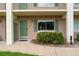 Condo unit entrance with green door and landscaping at 127 Oyster Bay Cir # 110, Altamonte Springs, FL 32701