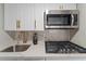 Close-up view of a kitchenette with stainless steel appliances at 127 Oyster Bay Cir # 110, Altamonte Springs, FL 32701