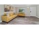 Living room featuring a mustard yellow sofa and wood-look vinyl flooring at 127 Oyster Bay Cir # 110, Altamonte Springs, FL 32701