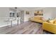 Living room with mustard yellow sofas and wood-look floors at 127 Oyster Bay Cir # 110, Altamonte Springs, FL 32701
