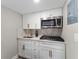Small galley kitchen with white shaker cabinets and gold hardware at 127 Oyster Bay Cir # 110, Altamonte Springs, FL 32701