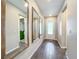 Bright and spacious entryway with wood-framed mirrors and tile floors at 1152 Mattie Pointe Blvd, Auburndale, FL 33823