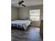 Bedroom with large bed, wood floor, and window at 32122 Hickory Ln, Sorrento, FL 32776