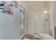 Bathroom with glass shower, toilet and door to outside at 1536 Maidstone Ct, Davenport, FL 33896