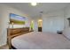 Comfortable bedroom with a queen bed, dresser, and mounted TV at 1536 Maidstone Ct, Davenport, FL 33896