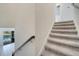 Carpeted staircase with modern railing overlooking a pool and backyard at 1536 Maidstone Ct, Davenport, FL 33896