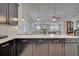Kitchen island with seating overlooking the living room at 1536 Maidstone Ct, Davenport, FL 33896