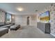 Game room with sectional sofa, TV, and accent wall at 1536 Maidstone Ct, Davenport, FL 33896