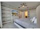 Main bedroom with wood-like wallpaper and large bed at 1536 Maidstone Ct, Davenport, FL 33896