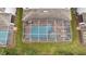 An aerial view of a screened-in pool and spa at 1536 Maidstone Ct, Davenport, FL 33896
