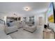 Bright living room with sectional sofa, large TV, and view into kitchen at 1536 Maidstone Ct, Davenport, FL 33896