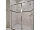 Bathroom with a large walk-in shower with marble tile at 1536 Maidstone Ct, Davenport, FL 33896
