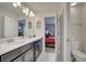 Modern bathroom with double sinks and a view into a bedroom at 1536 Maidstone Ct, Davenport, FL 33896