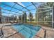 Inviting pool area with spa and screened enclosure at 1536 Maidstone Ct, Davenport, FL 33896