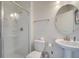 Bathroom boasts a toilet, sink, and a glass-enclosed shower at 1536 Maidstone Ct, Davenport, FL 33896
