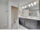 Bathroom with double vanity, toilet, and marble flooring at 1536 Maidstone Ct, Davenport, FL 33896