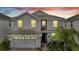 Two-story house with gray exterior and three-car garage at 1536 Maidstone Ct, Davenport, FL 33896