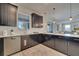 Modern kitchen with an island, dark cabinetry, and white quartz countertops at 1536 Maidstone Ct, Davenport, FL 33896