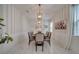 Elegant dining room with striped wallpaper and a large dining table at 1536 Maidstone Ct, Davenport, FL 33896