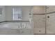 Bathroom with soaking tub, walk-in shower, and marble tile at 1536 Maidstone Ct, Davenport, FL 33896