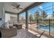 Covered patio with wicker furniture and view of the pool at 1536 Maidstone Ct, Davenport, FL 33896