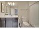 Clean bathroom with dark vanity, toilet and shower at 1536 Maidstone Ct, Davenport, FL 33896