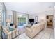 Living area with sliding doors leading to the pool and comfortable seating at 2918 Sunset Retreat Ct, Kissimmee, FL 34747