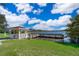 White gazebo near the lake, perfect for enjoying the view at 2918 Sunset Retreat Ct, Kissimmee, FL 34747