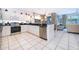 Open kitchen with stainless steel appliances and view into Gathering room at 2918 Sunset Retreat Ct, Kissimmee, FL 34747