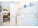 Well-lit laundry room with washer, dryer, and storage shelves at 2918 Sunset Retreat Ct, Kissimmee, FL 34747